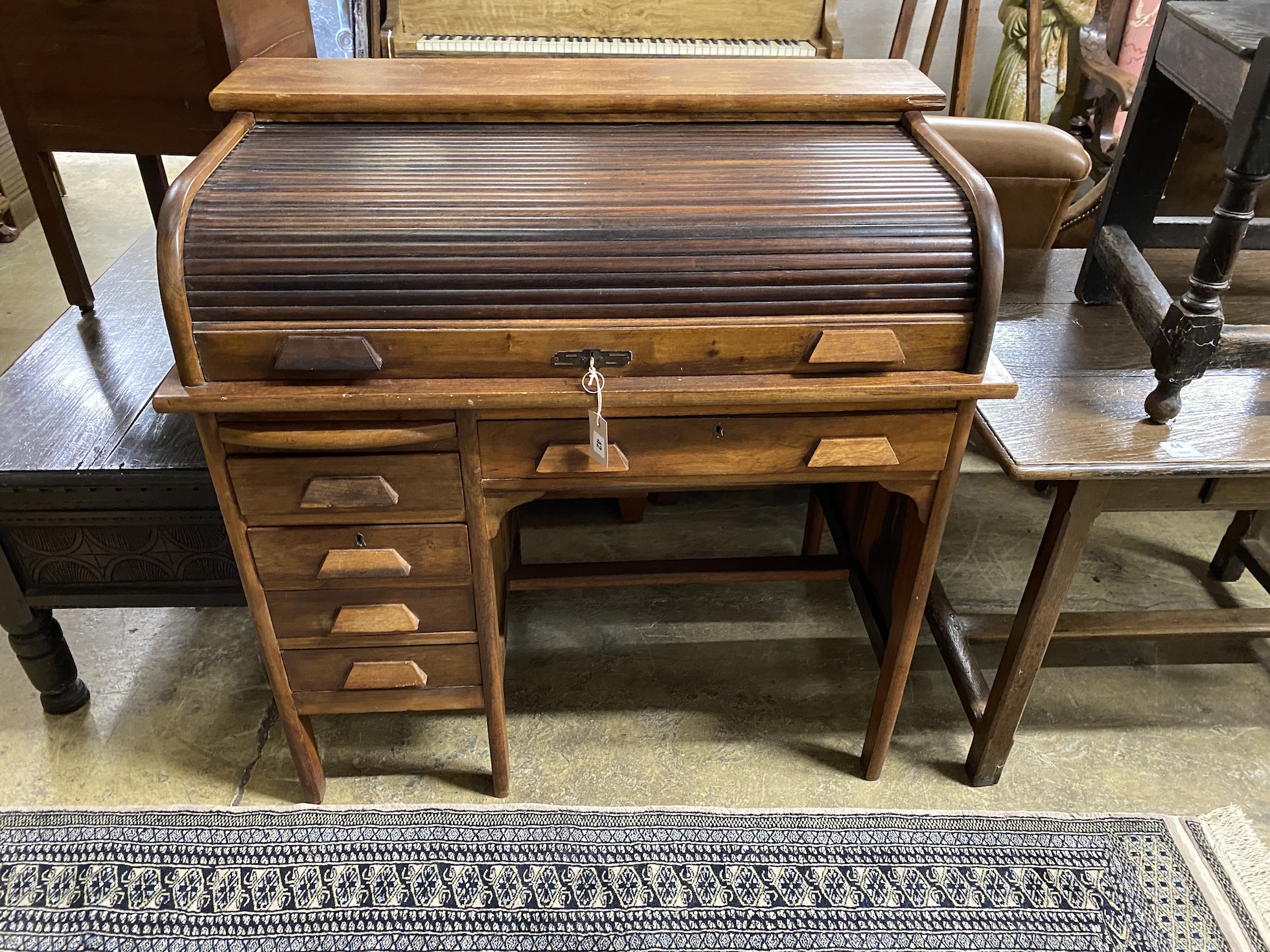 An early 20th century mahogany tambour kneehole writing desk, width 102cm, depth 62cm, height 103cm